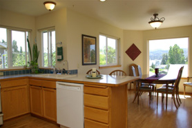 Now, we've added a plant, artwork and table runner to bring color into the kitchen and dining room.